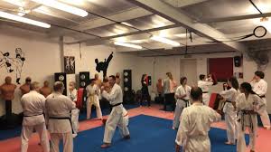 Woman kicking man to the front of the head